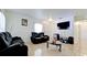 This living room features tile flooring, bright walls, a large tv and comfortable seating at 2330 28Th E Ave, Palmetto, FL 34221