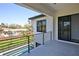 Relaxing balcony overlooking a yard with a pool and a neighborhood, blending outdoor living and privacy at 2335 Oak Ter, Sarasota, FL 34231