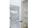 Bright bathroom features unique wallpaper, white tile flooring, and a well-lit interior at 2335 Oak Ter, Sarasota, FL 34231