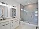 Bright bathroom featuring a dual vanity, tiled walk-in shower, and sleek modern design at 2335 Oak Ter, Sarasota, FL 34231