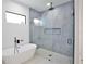 Bright modern bathroom features soaking tub and frameless glass shower at 2335 Oak Ter, Sarasota, FL 34231