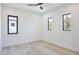 Bright bedroom with light wood flooring and modern black-framed windows at 2335 Oak Ter, Sarasota, FL 34231