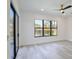 Bright bedroom features wood floors, a fan, and backyard views at 2335 Oak Ter, Sarasota, FL 34231