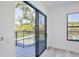 A sliding glass door offers backyard pool views from this bright bedroom at 2335 Oak Ter, Sarasota, FL 34231