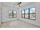 Spacious bedroom with three windows, wood-look floors, and a ceiling fan, bathed in natural light at 2335 Oak Ter, Sarasota, FL 34231