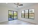 Bright bedroom offers a fan, backyard views, and wood flooring at 2335 Oak Ter, Sarasota, FL 34231