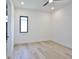 Minimalist bedroom with light wood floors, ceiling fan, and window at 2335 Oak Ter, Sarasota, FL 34231