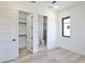 Bedroom with closet and bathroom entrances, light wood floors, and minimalist design at 2335 Oak Ter, Sarasota, FL 34231