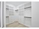 Bright walk-in closet with white cabinets and drawers at 2335 Oak Ter, Sarasota, FL 34231