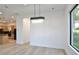 Dining area featuring hardwood floors, a modern chandelier, and views into the kitchen at 2335 Oak Ter, Sarasota, FL 34231