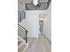 A modern home entryway with wood floors, staircase, and black railings at 2335 Oak Ter, Sarasota, FL 34231