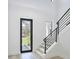 Bright home entryway with staircase, modern black railings, and natural light from exterior at 2335 Oak Ter, Sarasota, FL 34231