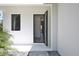 Modern home's open front door showcasing the clean, bright interior and wood flooring at 2335 Oak Ter, Sarasota, FL 34231