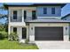 Contemporary two-story home with a dark garage door, complemented by a well-maintained lawn at 2335 Oak Ter, Sarasota, FL 34231