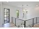 Well-lit hallway with black railings and an ornate hanging light fixture at 2335 Oak Ter, Sarasota, FL 34231