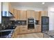 Modern kitchen features granite countertops, wood cabinets, and stainless steel appliances at 2335 Oak Ter, Sarasota, FL 34231
