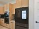 This kitchen features wood cabinets and a modern smart refrigerator at 2335 Oak Ter, Sarasota, FL 34231