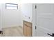 Bright laundry room with sink, wooden cabinets, and modern fixtures, offering a practical and stylish utility space at 2335 Oak Ter, Sarasota, FL 34231