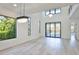 Spacious living room with soaring ceilings, modern chandeliers, and large windows overlooking lush greenery at 2335 Oak Ter, Sarasota, FL 34231