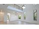 Bright living room features soaring ceilings, clerestory windows, modern chandeliers, and hardwood floors at 2335 Oak Ter, Sarasota, FL 34231