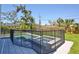 A private pool and spa are safely enclosed with a fence, nestled in a beautifully landscaped backyard at 2335 Oak Ter, Sarasota, FL 34231