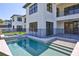 A pristine pool and spa are surrounded by a safety fence, with views of the home's exterior at 2335 Oak Ter, Sarasota, FL 34231