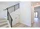 Modern staircase with light wood steps and a sleek black railing and storage closet at 2335 Oak Ter, Sarasota, FL 34231