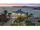 Stunning waterfront home boasts panoramic views of the bay and bridge, surrounded by lush palm trees at 2438 Baywood W Dr, Dunedin, FL 34698