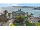 Stunning waterfront home boasts panoramic views of the bay and bridge, surrounded by lush palm trees at 2438 Baywood W Dr, Dunedin, FL 34698