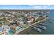 Aerial view of waterfront property with a pool, boat docks, and coastal neighborhood at 2438 Baywood W Dr, Dunedin, FL 34698