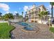 Beautiful backyard featuring a pool and jacuzzi, surrounded by a brick patio and well-maintained landscaping at 2438 Baywood W Dr, Dunedin, FL 34698