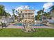 Expansive backyard pool with brick patio and lush landscaping perfect for outdoor entertaining at 2438 Baywood W Dr, Dunedin, FL 34698