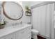 Bathroom featuring a vanity with drawers, a round mirror, modern fixtures, and a shower curtain at 2438 Baywood W Dr, Dunedin, FL 34698