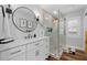 Stylish bathroom features a marble vanity, modern fixtures, and a glass-enclosed shower with decorative tile at 2438 Baywood W Dr, Dunedin, FL 34698