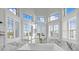 A pristine bathtub area with white marble accents and multiple windows that provide ample sunlight and outside views at 2438 Baywood W Dr, Dunedin, FL 34698