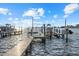 Well-maintained boat dock featuring multiple boat lifts and ample space for watercraft, ideal for boating enthusiasts at 2438 Baywood W Dr, Dunedin, FL 34698