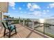 Inviting deck area with seating and a stunning waterfront panorama at 2438 Baywood W Dr, Dunedin, FL 34698