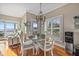 Cozy dining area features a round table, chandelier, and views of the waterfront from two shuttered windows at 2438 Baywood W Dr, Dunedin, FL 34698