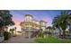 Beautiful elevated coastal home with a large front porch and well-manicured lawn, perfect for waterfront living at 2438 Baywood W Dr, Dunedin, FL 34698