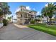 Beautiful elevated coastal home with a large front porch and well-manicured lawn, perfect for waterfront living at 2438 Baywood W Dr, Dunedin, FL 34698