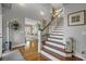 Elegant foyer with hardwood floors, a staircase, and tasteful decor creating a warm and inviting entrance at 2438 Baywood W Dr, Dunedin, FL 34698