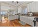 Well-lit kitchen with stainless steel appliances, shaker cabinets, and an open layout adjacent to dining and living areas at 2438 Baywood W Dr, Dunedin, FL 34698