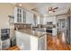 Open-concept kitchen with a kitchen island, barstool seating, shaker cabinets, stainless steel appliances, and ample counter space at 2438 Baywood W Dr, Dunedin, FL 34698