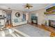 Relaxing living room featuring a fireplace, a decorative fish tank, neutral walls, hardwood floors, and stylish decor at 2438 Baywood W Dr, Dunedin, FL 34698