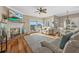 Cozy living room with a fireplace, access to a patio, and an adjacent dining area with lots of natural light at 2438 Baywood W Dr, Dunedin, FL 34698