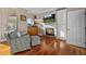 Cozy living room featuring a fireplace, built-in cabinets, hardwood floors, and a comfortable patterned chair and ottoman at 2438 Baywood W Dr, Dunedin, FL 34698