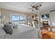 Bedroom with waterfront view, fireplace, and hardwood floors at 2438 Baywood W Dr, Dunedin, FL 34698