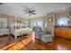 Bright bedroom featuring hardwood floors, sitting area, and water views at 2438 Baywood W Dr, Dunedin, FL 34698