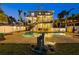 Inviting outdoor pool area features brick pavers, a covered patio, and lush landscaping for relaxation at 2438 Baywood W Dr, Dunedin, FL 34698