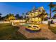 Backyard pool and spa with brick pavers, lush landscaping, and a two-story home at 2438 Baywood W Dr, Dunedin, FL 34698